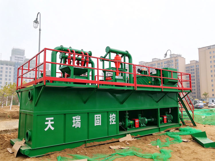 Geothermal drilling solids control skid with shale shaker and desander/desilter hydrocyclones at a Xi’an well site.